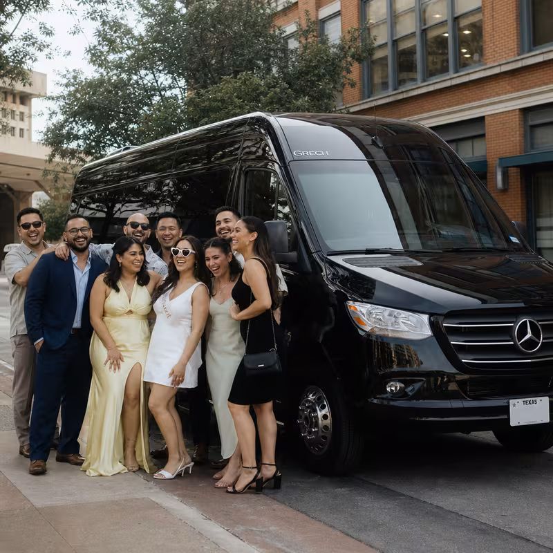 Group boarding a white charter bus for Bachelor & Bachelorette Transportation transportation in San Antonio