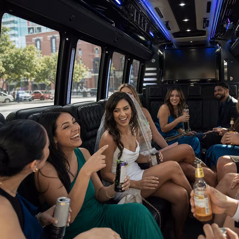 Party bus interior with wraparound leather seating and LED lighting in San Antonio