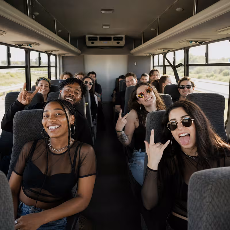 Party bus interior with wraparound leather seating and LED lighting in San Antonio