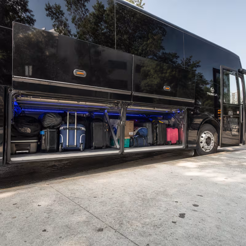 Party bus interior with wraparound leather seating and LED lighting in San Antonio