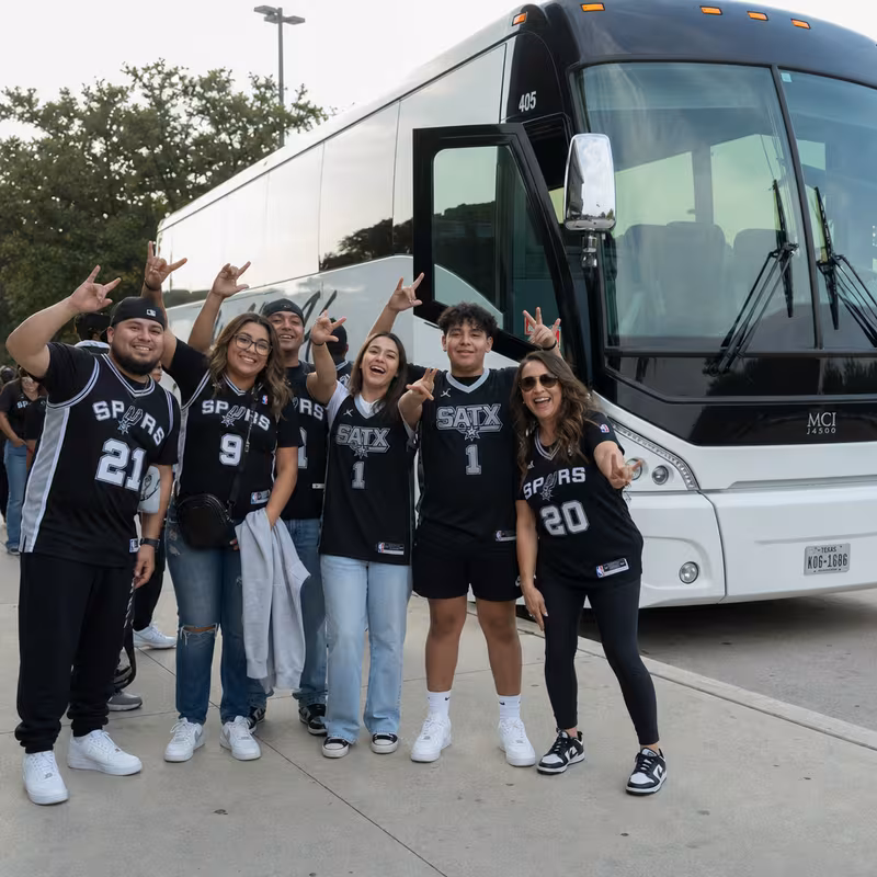 Passengers loading luggage while boarding an San Antonio group shuttle
