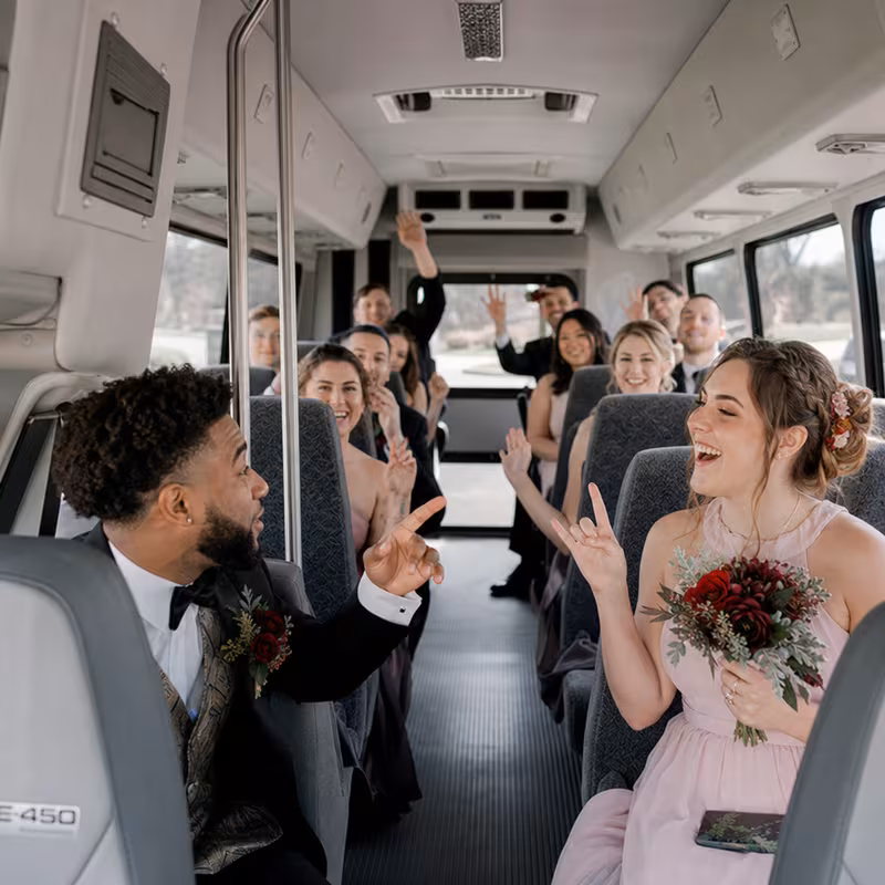 Group boarding a white charter bus for Wedding Transportation transportation in San Antonio