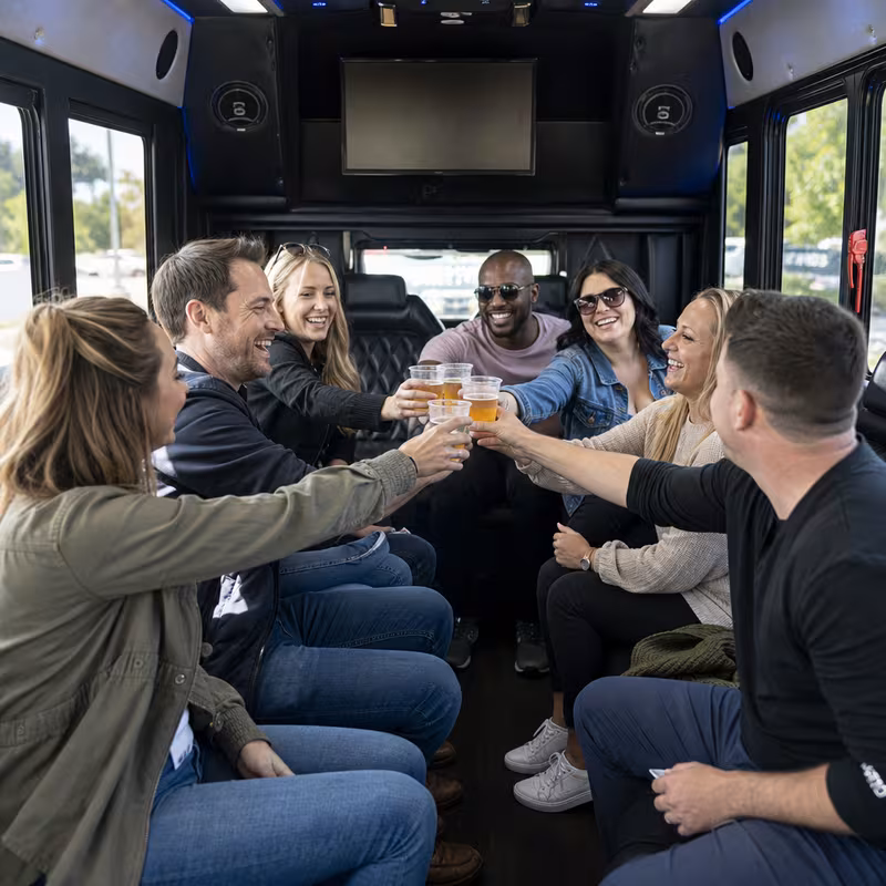Group boarding a white charter bus for Winery & Brewery Tour Transportation transportation in San Antonio