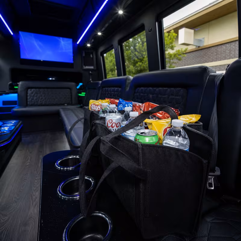 Party bus interior with wraparound leather seating and LED lighting in San Antonio